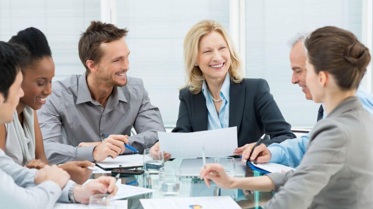 Employees Smiling In Team Meeting