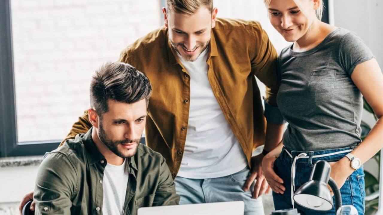 Group of Young Managers Working Together With Laptop at the Office