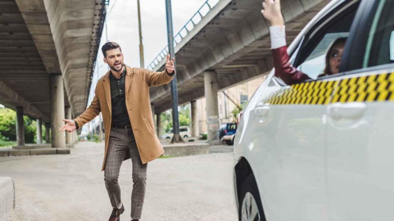 Man in a Coat Waving to a Person in a Taxi Cab