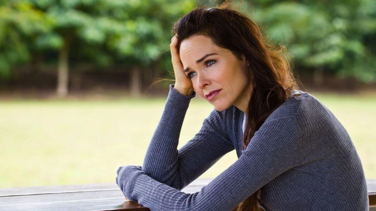 Sad Looking Woman Sitting Outdoors