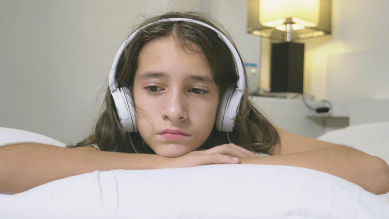 Sad Young Girl Wearing Headphones