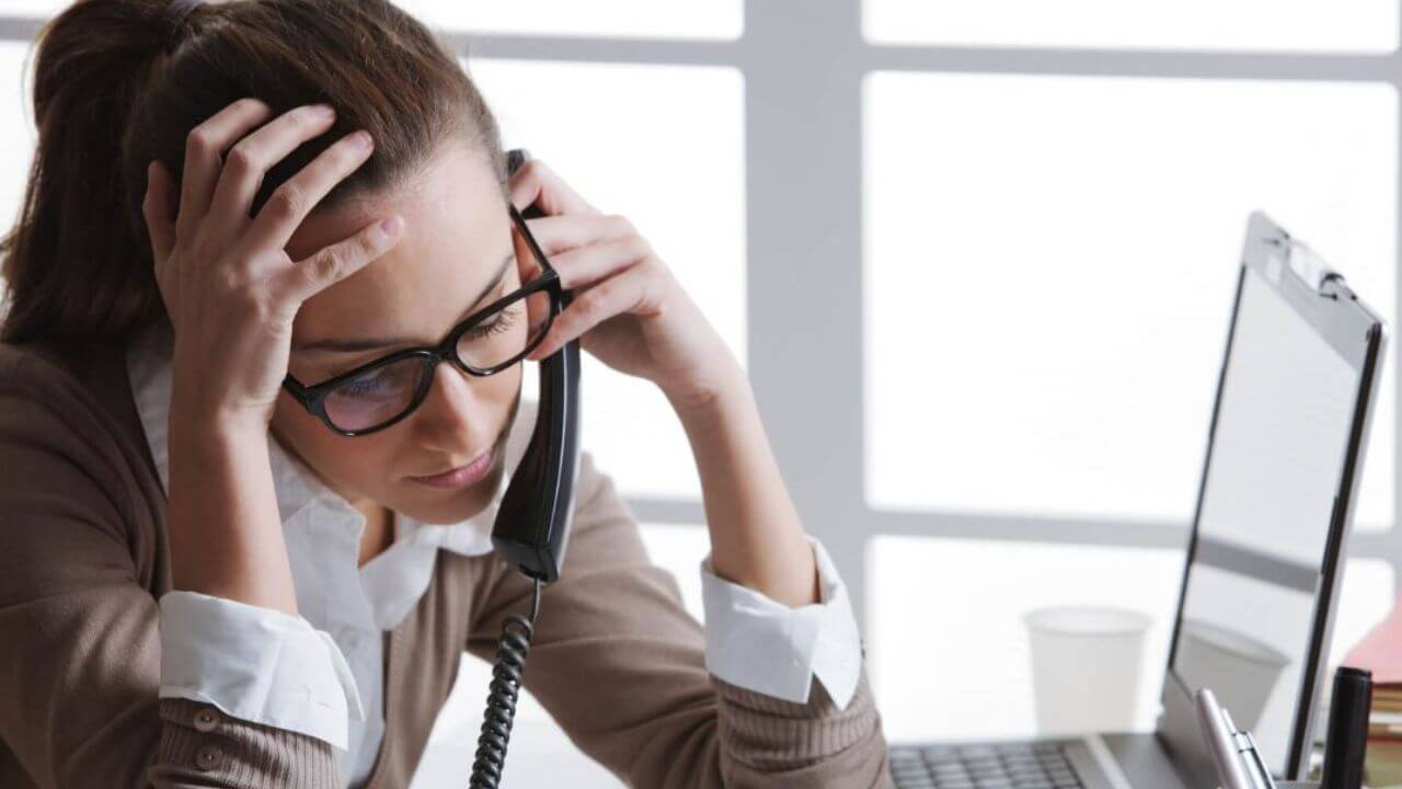 Tired Stressed Woman In Front Of Laptop At Work