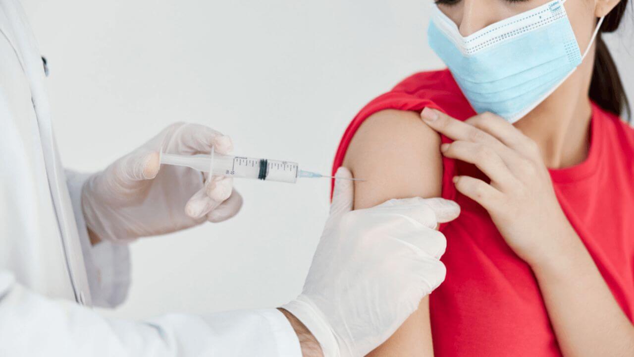 Vaccine on a Masked Lady in Red Shirt