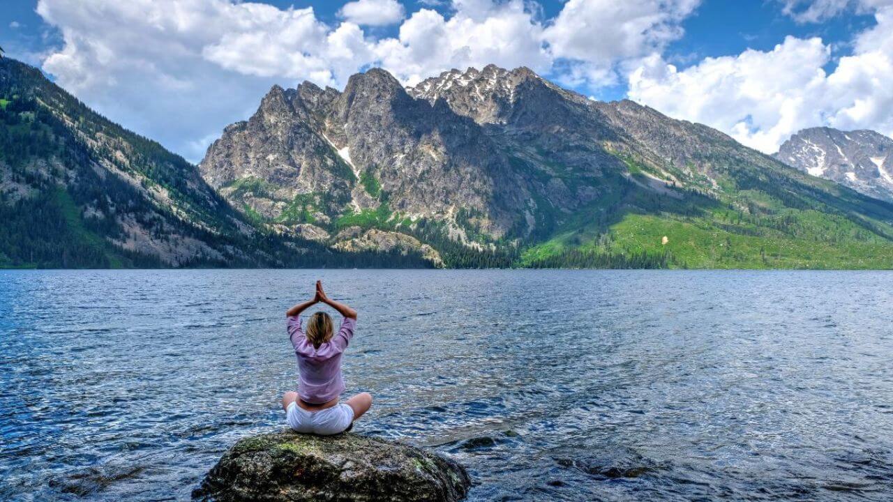 Woman Doing Yoga at a Beautiful Lake